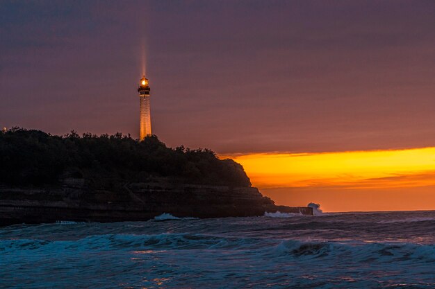 Phare de Biarritz illuminé dans un magnifique coucher de soleil. France