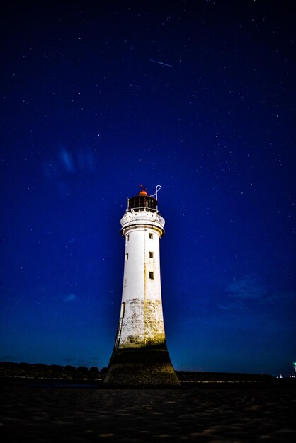 Photo un phare contre le ciel la nuit