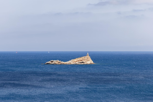 Phare de Scoglietto sur îlot rocheux sans végétation dans le canal de Piombino, île d'Elbe, Italie