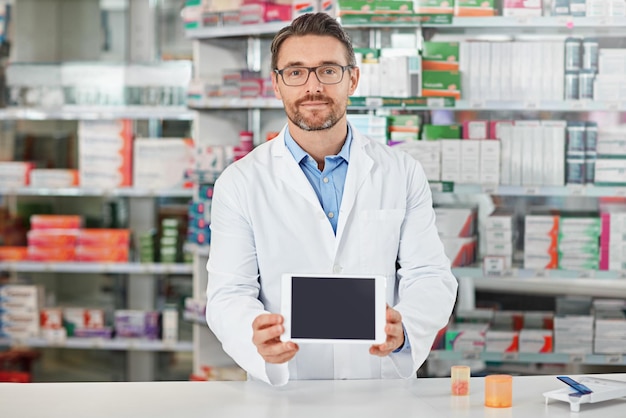 Pharmacien homme boutique et portrait avec mise au point sur l'écran de la tablette et mise au point pour la commercialisation de médicaments ou la vente Expert pharmaceutique professionnel de la santé et technologie numérique mobile en pharmacie pour le bien-être avec application