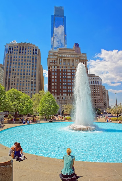 Philadelphie, États-Unis - 4 mai 2015 : Fontaine dans le Love Park de Philadelphie, Pennsylvanie, États-Unis. Touristes dans le parc. Skyline avec des gratte-ciel en arrière-plan