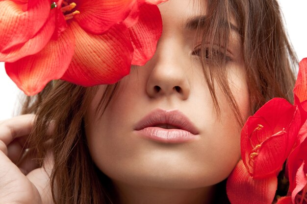 photo de belle femme avec des fleurs rouges