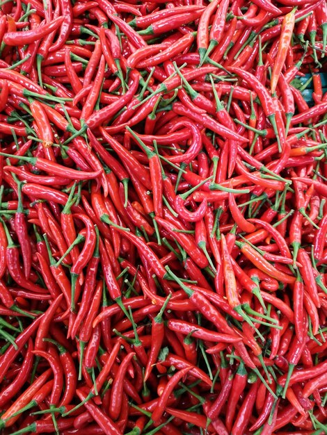 Une photo complète de poivrons rouges à vendre au marché.