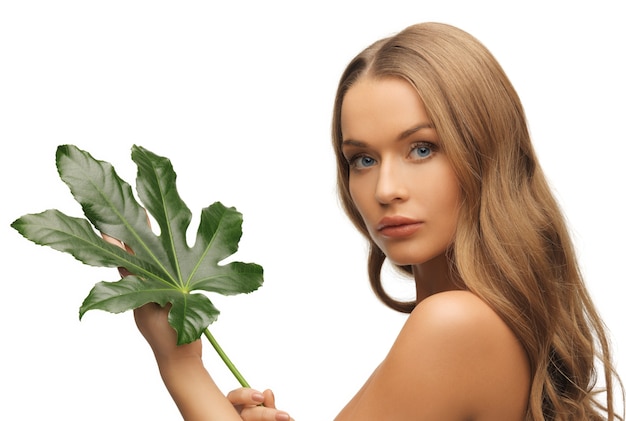 Photo photo de femme avec une feuille verte sur blanc.