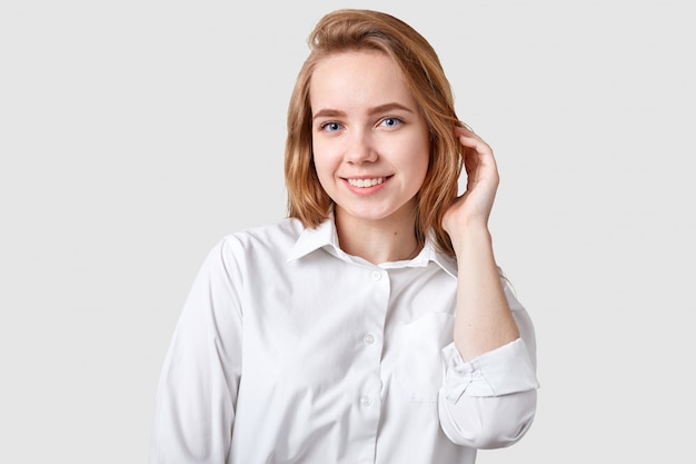 Photo d'une femme à la recherche agréable avec un sourire à pleines dents