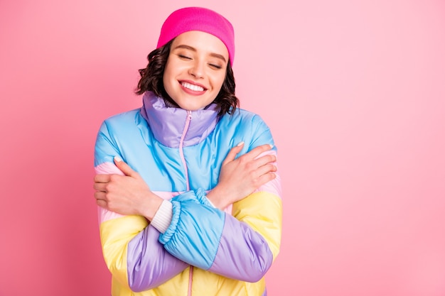 Photo gros plan de belle dame tenant par la main manteau de couleur chaude isolé fond rose