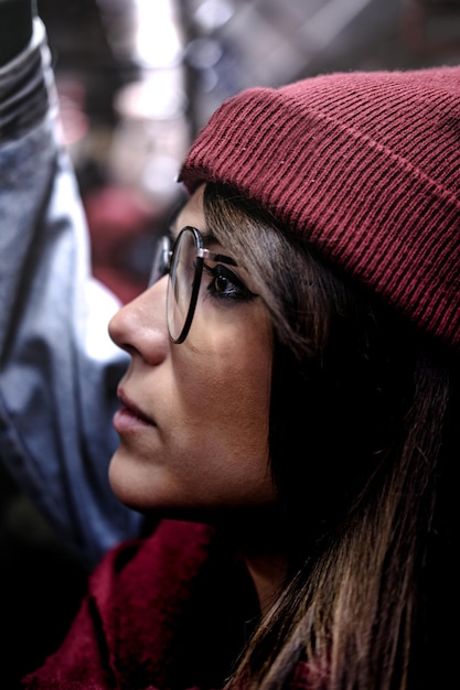 Photo en gros plan d'une femme hipster en vêtements magenta dans les transports en commun