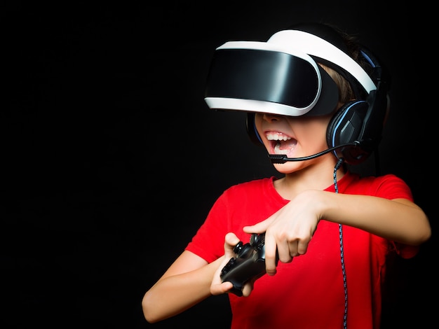 La photo en gros plan d'une jeune fille en VR jouant à des jeux vidéo avec un visage excité.