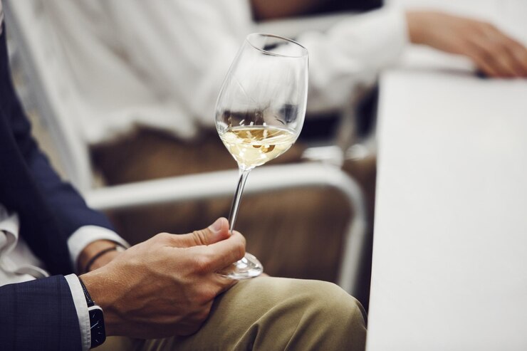 Photo photo en gros plan d'un sommelier qualifié dégustant du vin blanc lors d'une formation d'experts en vin sur des cours