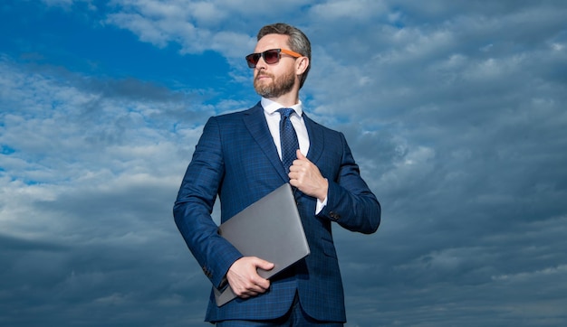 Photo d'un homme d'affaires confiant avec un ordinateur portable