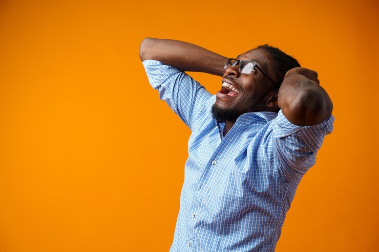 Photo photo d'un homme noir excité, extatique et heureux sur un fond jaune