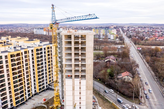 Photo d'un immeuble à plusieurs étages en construction Construction d'un gratte-ciel résidentiel Image d'arrière-plan du processus de construction d'une maison avec des grues Un immeuble de grande hauteur en construction