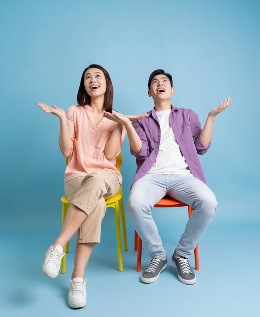 Photo d'un jeune couple asiatique sur fond bleu