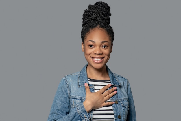 Photo d'une jeune femme excitée à la peau foncée en veste en jean