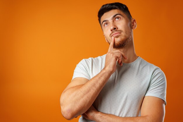 Photo d'un jeune homme attentionné touchant son menton