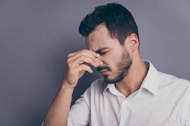 Photo de profil de jeune homme d'affaires tenir le pont du nez souffrir de migraines maux de tête