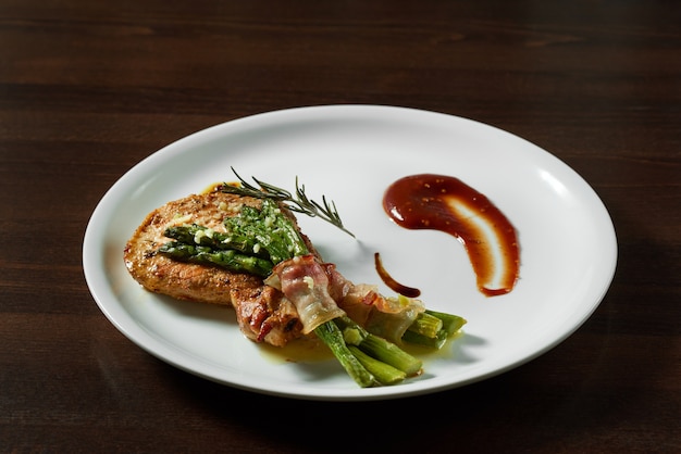 Photo d&#39;un steak fumé servi avec du bacon et des asperges au restaurant