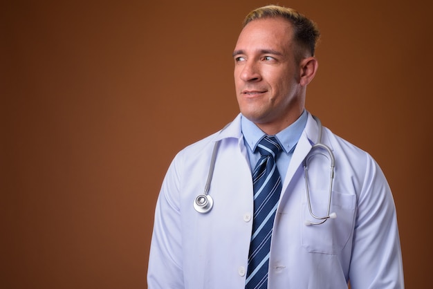 Photo de Studio d'homme médecin pensant sur brown