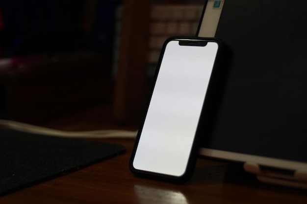 Photo d'un téléphone portable vide avec écran blanc sur la table