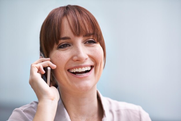 Photo de la tête et des épaules d'une jeune femme d'affaires parlant sur un téléphone portable