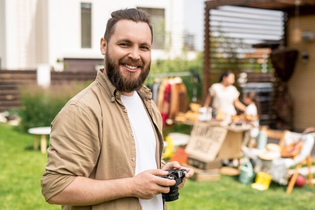 Photographe barbu à la vente de garage