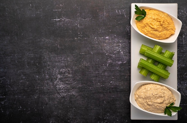 Photographie culinaire de houmous et de céleri à l'apéritif