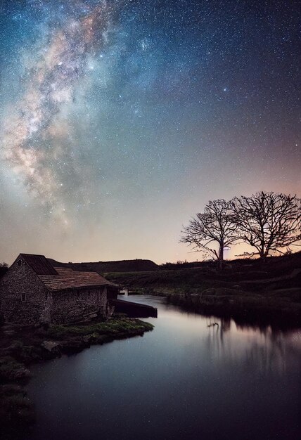 Photographie de la nature Un grand moulin à eau avec la voie lactée au-dessus de l'illustration de style 3d