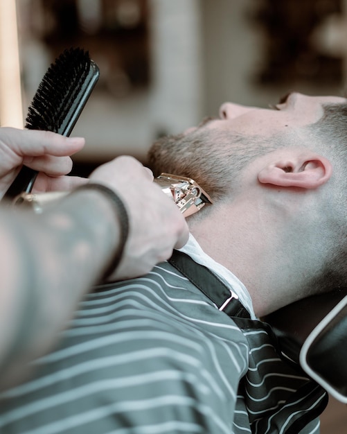 photographie de salon de coiffure portrait d'un homme pendant la coupe de cheveux