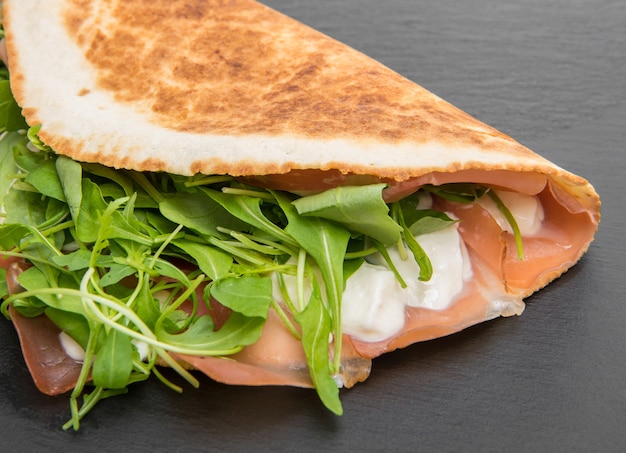 Piadina romagnole typique avec jambon, fromage et roquette