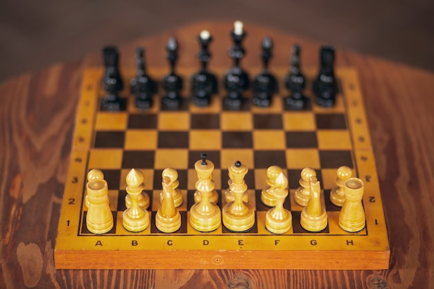 Pièces d'échecs en bois sur un jeu de société, sur table vintage, mise au point sélective.