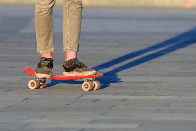 Pieds d'adolescents faisant de la planche à roulettes dans la ville. Loisirs et loisirs des adolescents