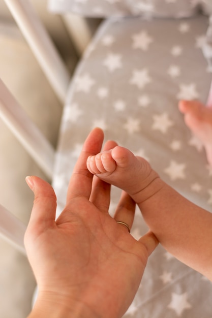 Photo pieds de bébé dans la main de la mère.