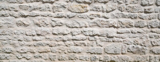 Photo pierre web en-tête vieux mur vintage texture panoramique grand fond bardage pierres de tailles différentes