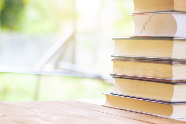 Pile de livres épais avec belle lumière et fond Bokeh.