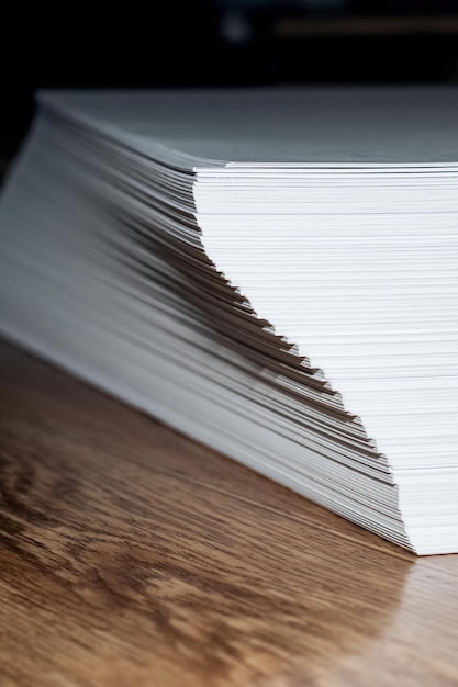 Pile de papier blanc sur une table en bois