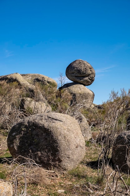 Une pile de roches est en équilibre au-dessus de quelques rochers.