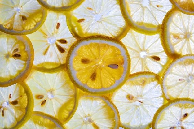 Photo pile de tranches de citron jaune qui se chevauchent créé un mur de citrons en arrière-plan