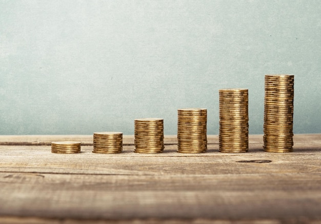 Piles de pièces d'or sur table en bois