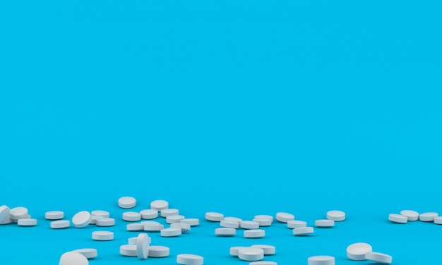 Pilules de médecine éparpillées sur fond bleu clair