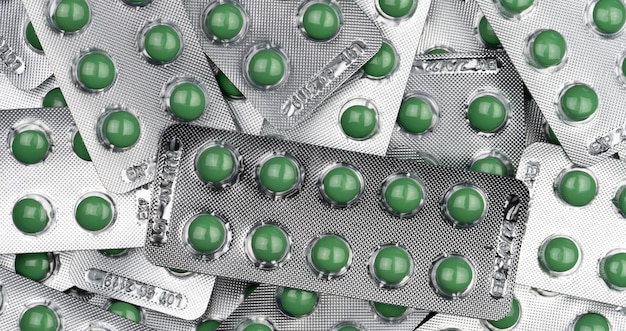 Photo pilules rondes vertes plein cadre sous blister médicaments sur ordonnance vue de dessus des comprimés verts