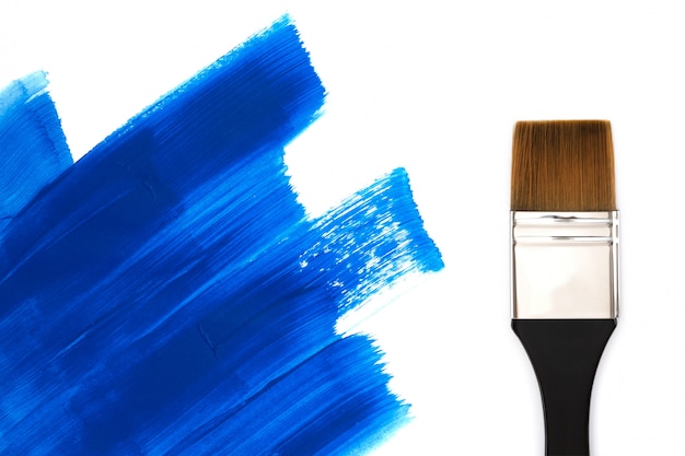 Photo pinceau et traits de peinture bleue.