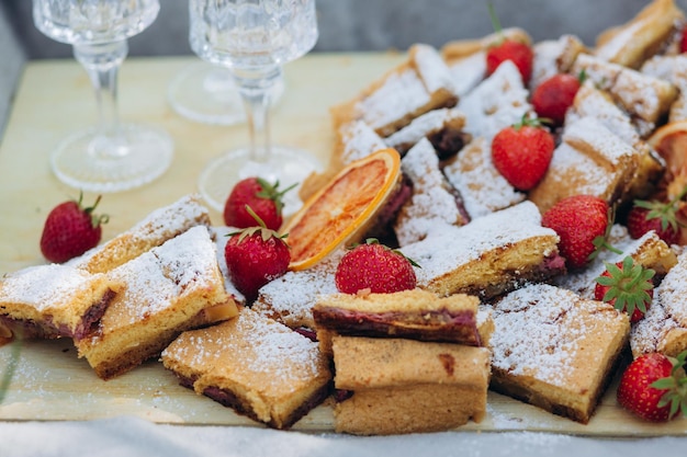 Pique-nique dans le parc avec de délicieuses pâtisseries et des fraises en gros plan sur la nourriture