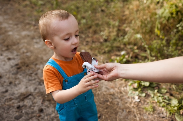 pique-nique sain dans la forêt. enfant heureux qui mange