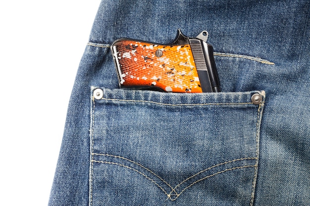 Photo pistolet dans la poche d'un jean.