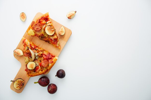 Pizza aux figues sur table blanche