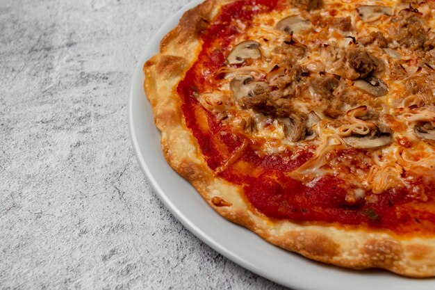 Pizza maison avec tomates fromage champignons thon légumes jambon et herbes fraîches avec copie espace