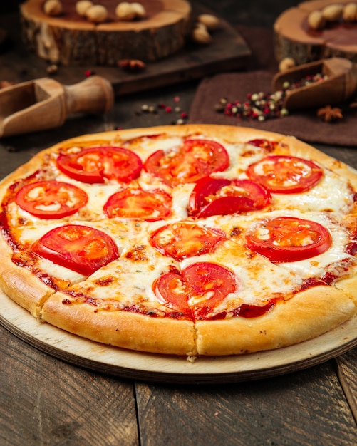 Pizza Margarita sur la table décorée en bois