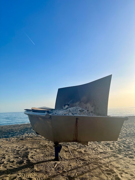 La plage du coucher du soleil avec une cheminée remplie de cendres