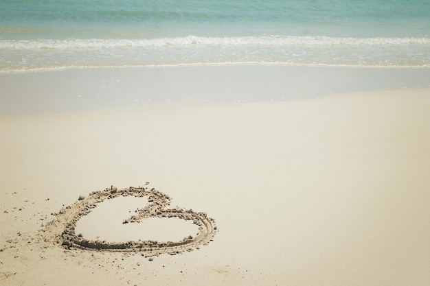 Plage en forme de coeur avec de l'eau bleu vif