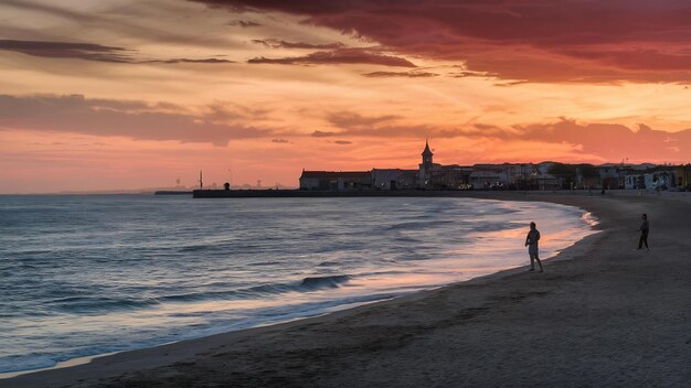 Photo plage lors d'un coucher de soleil à gijon, en espagne